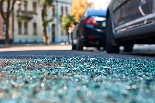 Shattered glass on the road at the scene of a car accident in Tampa